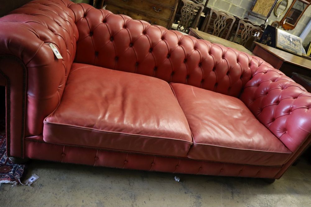 A Victorian style buttoned pale red leather Chesterfield settee, width 220cm depth 100cm height 74cm